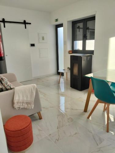 a living room with a couch and a glass table at Costa Home in Gafanha da Nazaré