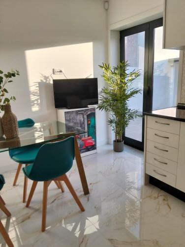 a living room with a table and chairs and a fireplace at Costa Home in Gafanha da Nazaré