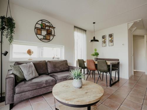 a living room with a couch and a table at Apartment in Waterpark with Private Jetty in Uitgeest