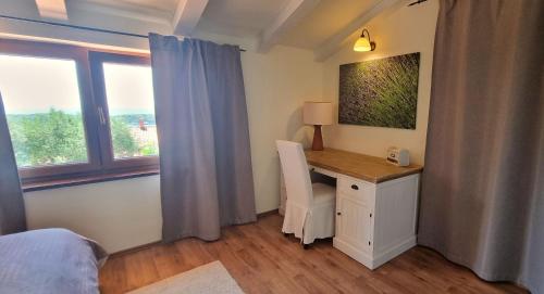ein Schlafzimmer mit einem Schreibtisch und einem Bett und einem Fenster in der Unterkunft Villa Rapkinja in Mundanije