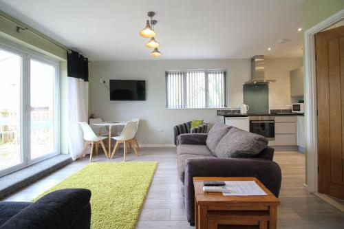 a living room with a couch and a table at Gwel An Koos in Bodmin