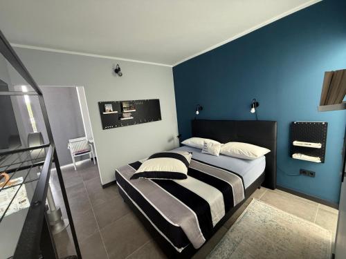 a bedroom with a bed with a blue wall at Villa Claus in Puerto Calero