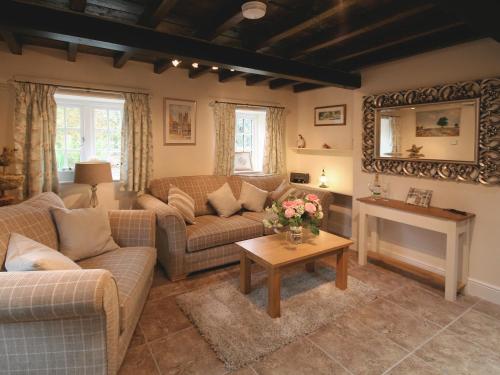 ein Wohnzimmer mit zwei Sofas und einem Tisch in der Unterkunft Chestnut Cottage - E5625 in Wainfleet All Saints