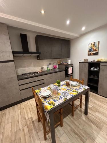 a kitchen with a table and chairs and a kitchen with at Casa Cristina2 in Grottaferrata