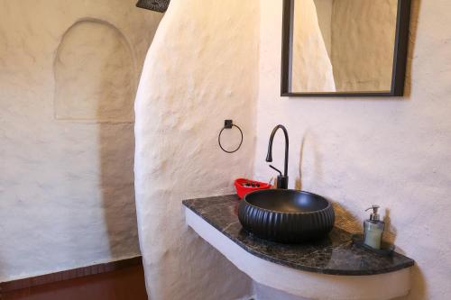 a bathroom with a sink and a mirror on a counter at naya port in Alacati