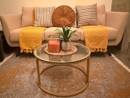 a living room with a couch and a table with a candle at Casablanca in Dwarskersbos