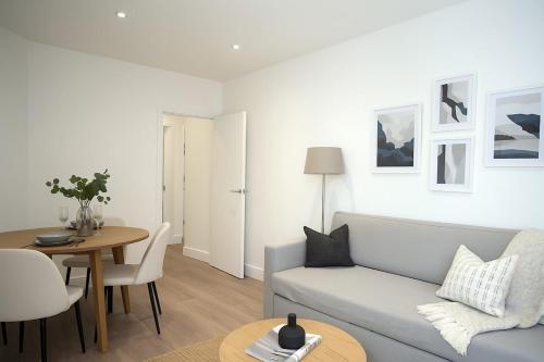 a living room with a couch and a table at Euston, Russel Square, Kings Cross Designer's Stay in London
