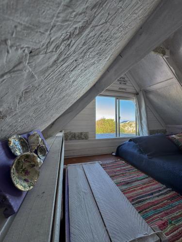 a bedroom in a tent with a bed and a window at Solar Valizas in Barra de Valizas