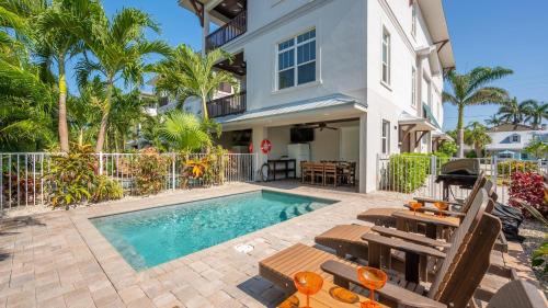a villa with a swimming pool and a house at Casa Coquina - 1038U in Siesta Key