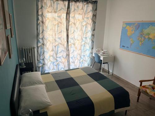 a bedroom with a bed and a window and a table at Jaky Maison Torino, Cozy & Modern Stay in Turin