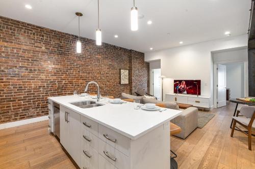 a kitchen and living room with a brick wall at The Saddlery-Setlist-4 Combo Unit-Walk to Broadway in Nashville