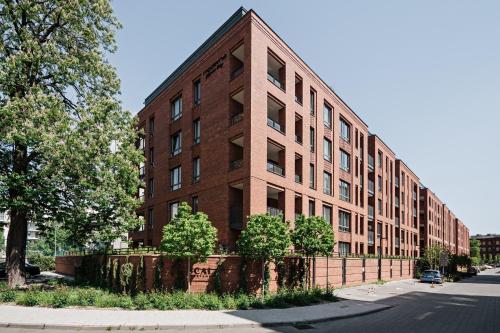 a brick building on the side of a street at Gdańsk Old Town Scala Premium Apartments D with Parking by Lion Apartments in Gdańsk