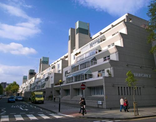 a building on a street with people walking in front of it at Euston, Russel Square, Kings Cross Designer's Stay in London