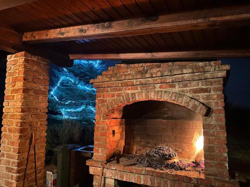 a brick oven with a fire inside of it at Podroom LauMarYvo in Dugo Selo