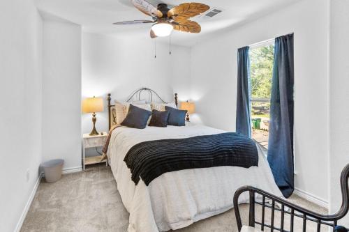 a bedroom with a bed and a ceiling fan at The Tree House on Lake Brownwood in Brownwood