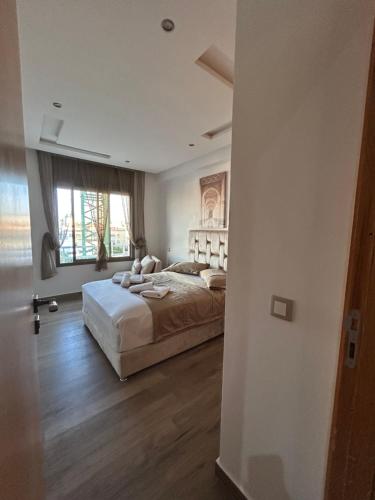a bedroom with a bed and a window at Rabat Explorer Apartment in Rabat