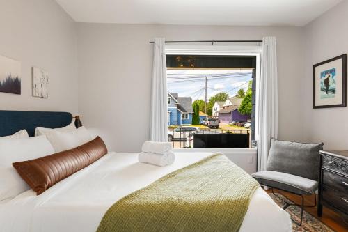 a bedroom with a bed and a chair and a window at Downtown Home Walk to Restaurants and Waterfront in Tacoma