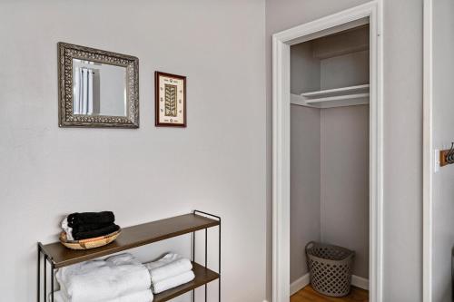a bathroom with a mirror and a shelf with towels at Downtown Home Walk to Restaurants and Waterfront in Tacoma