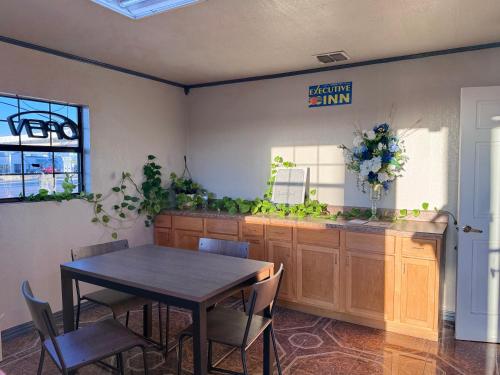 a dining room with a table and a sign on the wall at Executive inn in Crystal City