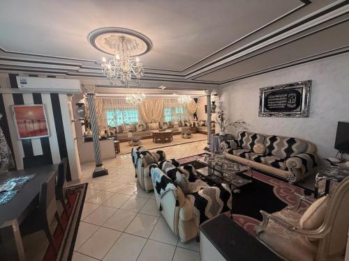 a large living room with couches and a chandelier at Tradicional & Luxury Apartment City Center & Beach & WiFi! in Tangier