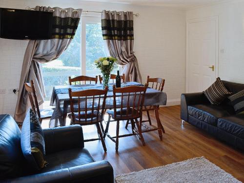 a living room with a table and a couch at River View Villa - Cv44 in Saint Cleer