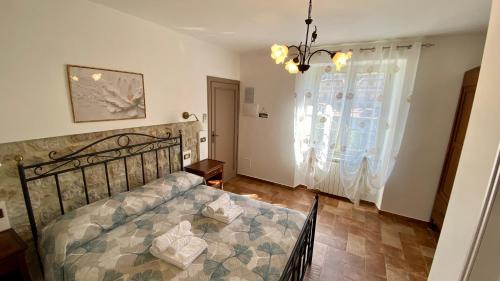 a bedroom with a bed and a large window at La Casa Di Nonna Tella in Lenola