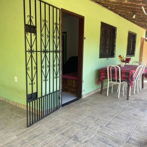 a door to a patio with a table and chairs at Casa no Sítio - Guaramiranga in Guaramiranga