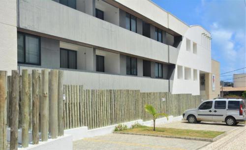 a white van parked in front of a building at Joan Miro Flat - Ponta Negra in Natal