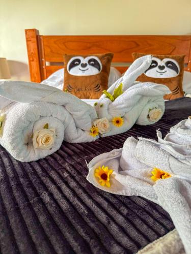 two owls wrapped in towels on a bed at Refugio Las Cortezas in Tapantí