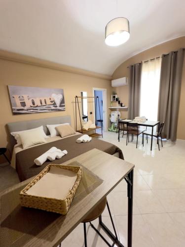 a living room with a bed and a table at Ma Maison Etnea in Catania