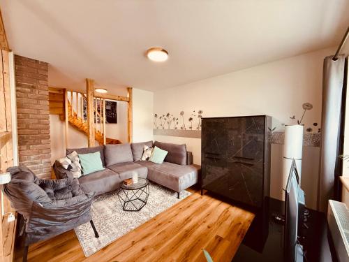 a living room with a couch and a table at Fabians Ferienhaus - 4 besondere Ferienwohnungen in Simmerath