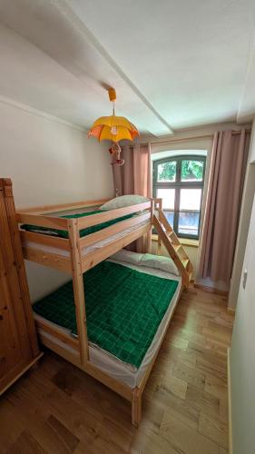 two bunk beds in a room with a window at Oben im Selketal Erste Etage in Harzgerode