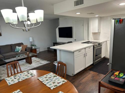 a kitchen and living room with a table and a couch at Desert Dwelling Resort Near Papago Park in Phoenix