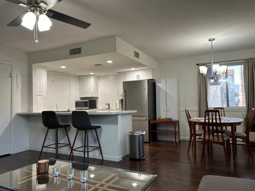 a kitchen with white cabinets and a table and chairs at Desert Dwelling Resort Near Papago Park in Phoenix