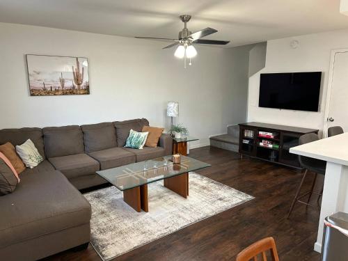 a living room with a couch and a flat screen tv at Desert Dwelling Resort Near Papago Park in Phoenix