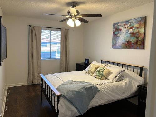 a bedroom with a bed with a ceiling fan at Desert Dwelling Resort Near Papago Park in Phoenix