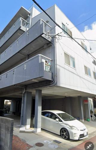 a white car parked in front of a building at 瀬戸雲来 seto unrai 302 in Takamatsu