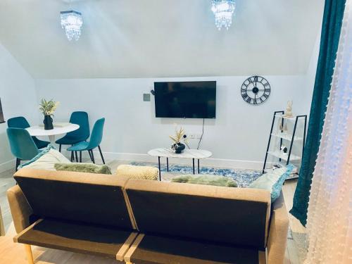 a living room with a couch and two tables and a tv at Modern Flat Near Dover Castle in Dover