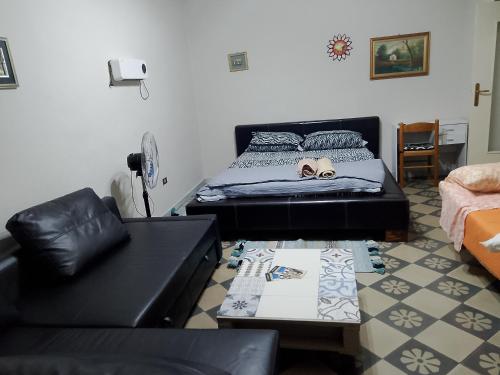 a living room with a bed and a couch at ARCO in Bisceglie