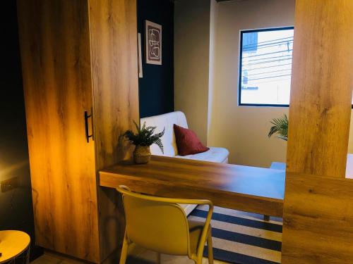 a room with a wooden table and yellow chairs at HAB 108- Hermosa, cómoda y moderna in Medellín