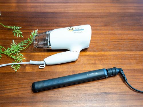 a hair dryer sitting on top of a wooden table at 海街ゲストハウス in Takamatsu