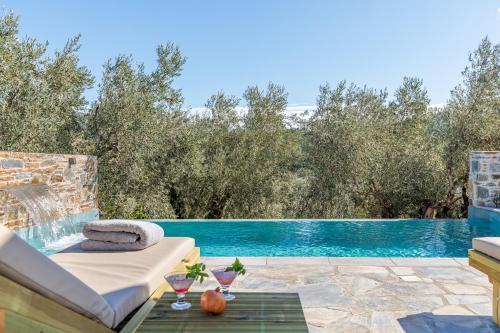 a villa with a swimming pool and a patio at Luxury VILLA RAFAEL in Skopelos Town