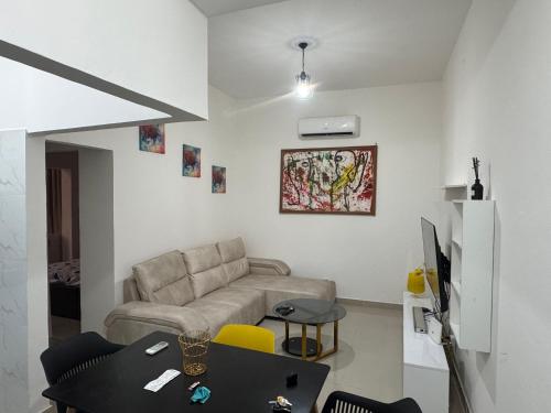 a living room with a couch and a table at Apartamento 1 Quarto - Baixa de Luanda in Luanda