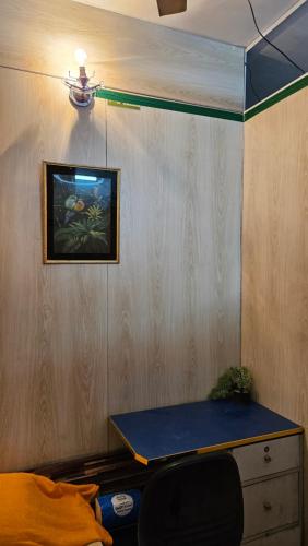 a room with a desk and a painting on the wall at Sky Garden Home in Dhaka