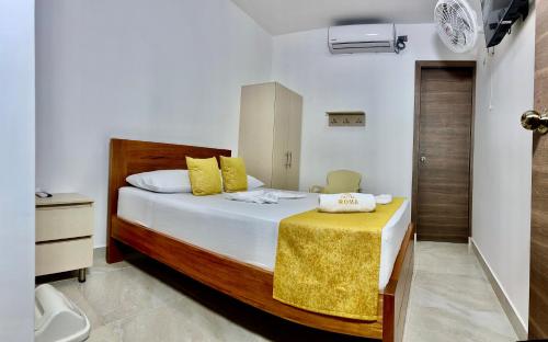 Giường trong phòng chung tại Hotel Roma Urabá