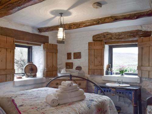 a bedroom with a bed with towels on it at The Old Sheaf Store - Kyz in Glaisdale