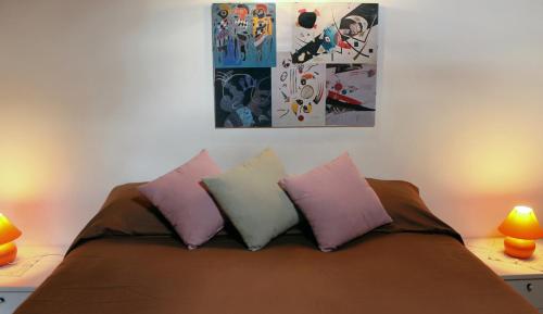 a bedroom with a bed with three pillows on it at B&B La Borella Casa Conti in Vallouise