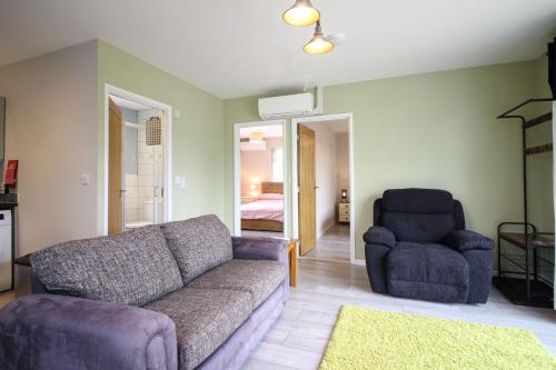 a living room with a couch and a chair at Gwel An Koos in Bodmin