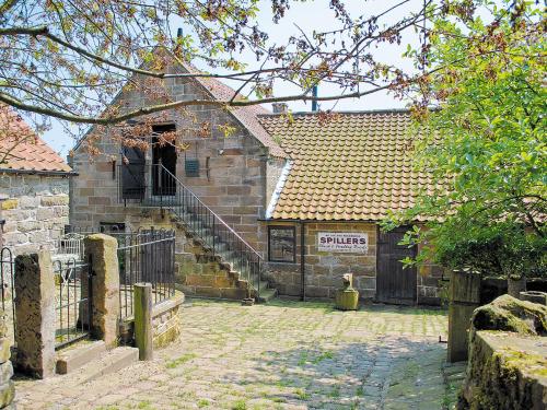 an old building with a gate and stairs in front of it at The Hayloft - Igp in Glaisdale