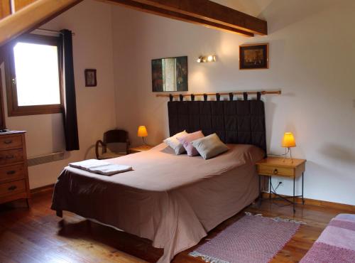 a bedroom with a large bed and a window at B&B La Borella Casa Conti in Vallouise